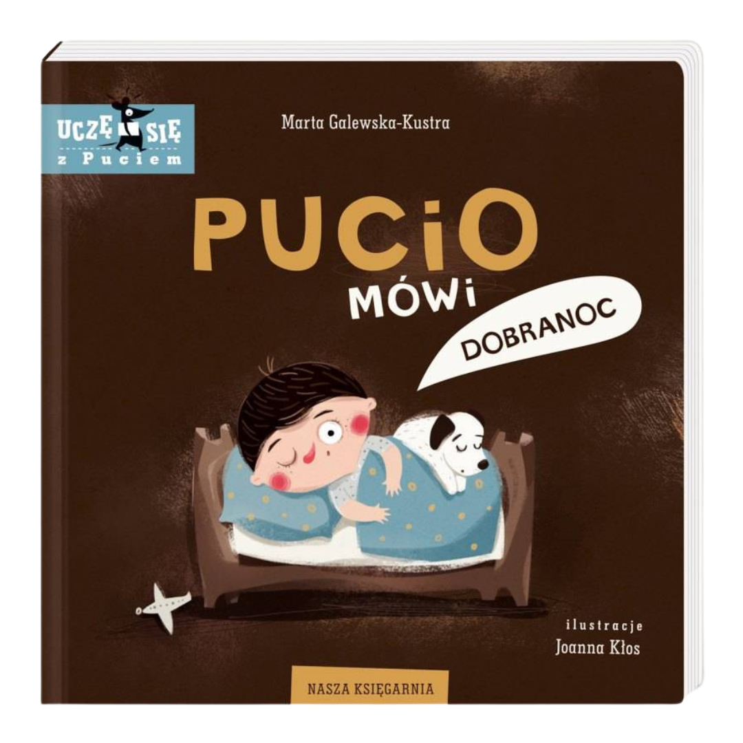 Okładka książki „Pucio mówi dobranoc” – Pucio z pieskiem leżą na łóżku, książka edukacyjna dla najmłodszych dzieci.